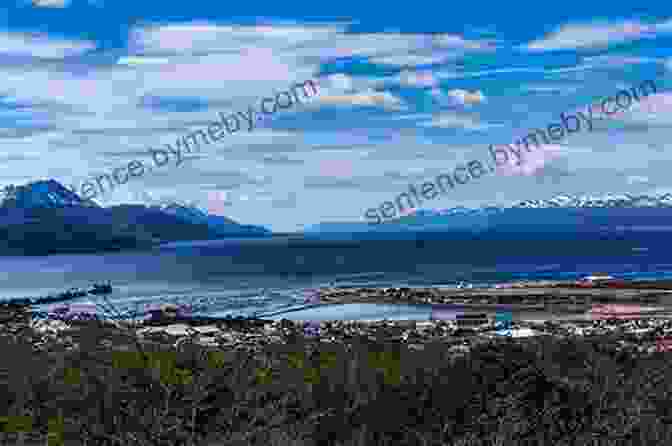 A Breathtaking View Of The Beagle Channel, Surrounded By Towering Mountains And Pristine Waters. The 1886 Exploration Of Tierra Del Fuego