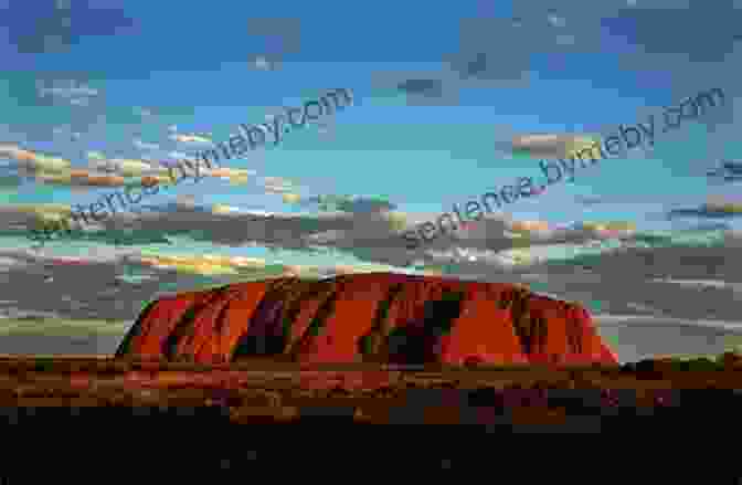 A Vast Red Desert Landscape With Uluru In The Distance The Dog Fence: A Journey Across The Heart Of Australia