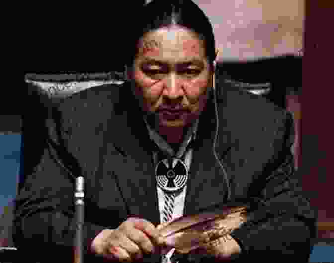 Elijah Harper, A Man With A Serious Expression, Wearing A Suit And Tie, And A Feather In His Hair Elijah Harper Politician Peacemaker Pioneer Of The Oji Cree Tribe Canadian History For Kids True Canadian Heroes Indigenous People Of Canada Edition